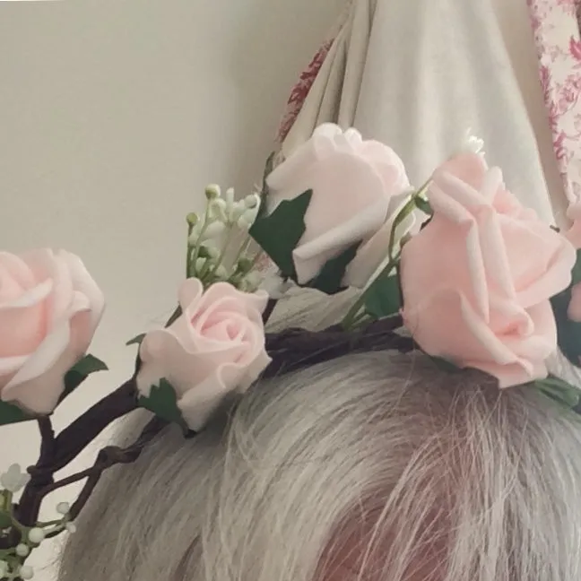 a flower crown of pale pink artificial rose flowers